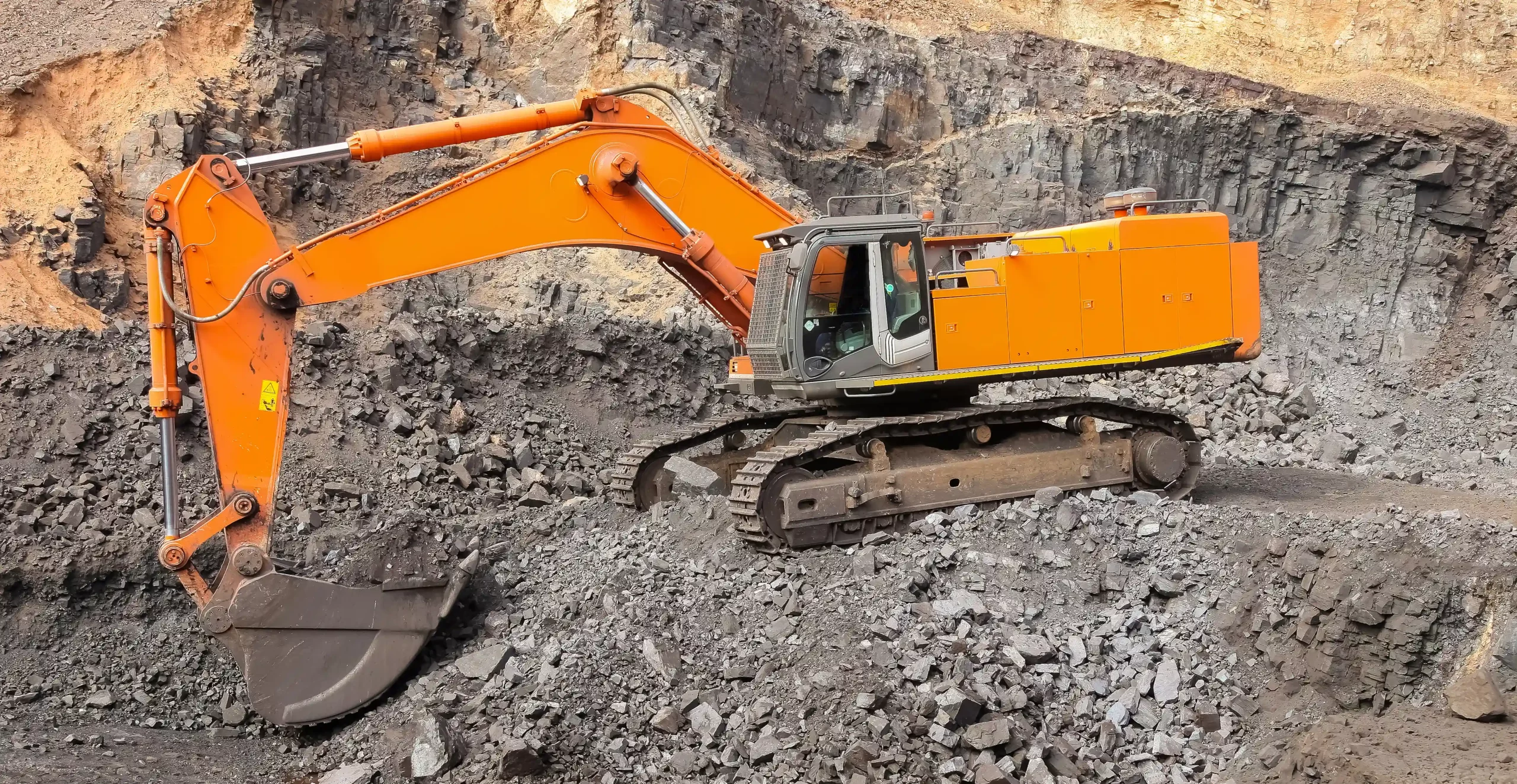 1 yellow-excavator-digging-ore-rich-rock-open-pit-mine